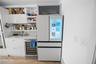 Modern kitchen featuring a Samsung smart French-door refrigerator with integrated touchscreen display.