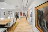 Open dining area with refined finishes and a beautifully illuminated hallway.
