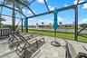 Expansive screened patio overlooking the lake and illuminated fountain.