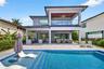 Salt chlorinated pool w/ water features, LED color changing light, sun shelf with umbrella hole and in water stools. Stone decking surrounds the pool