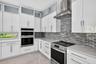 Chef's kitchen w/ counter seating, quartz waterfalls, 2 ovens, pot filler, tons of storage, KraftMaid cabinets