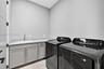Upstairs laundry room conveniently by the bedrooms w/ laundry tub