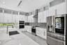Chef's kitchen w/ counter seating, quartz waterfalls, 2 ovens, pot filler, tons of storage, KraftMaid cabinets