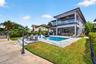 View from the new concrete dock and seawall to the Salt chlorinated pool w/ water features, LED color changing light, sun shelf with umbrella hole and