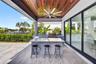 Covered patio w/ T&G ceilings, fans, fire pit seating and outdoor kitchen overlooks the gorgeous wide New River views and pool area