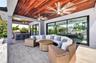 Covered patio w/ T&G ceilings, fans, fire pit seating and outdoor kitchen overlooks the gorgeous wide New River views and pool area