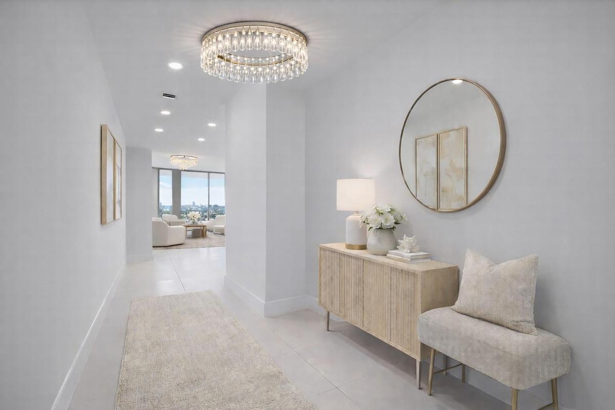 The entryway of the condo, chandelier not included. Virtually staged.