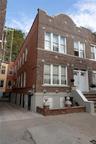 Brick facade featuring decorative stone accents and multiple windows