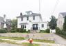 White clapboard exterior with black entry door