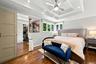 King-size primary bedroom with tray ceiling and double closets