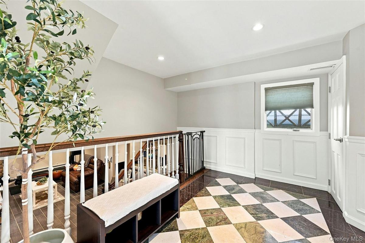 Foyer leads to a laundry room and half bath and the lower level