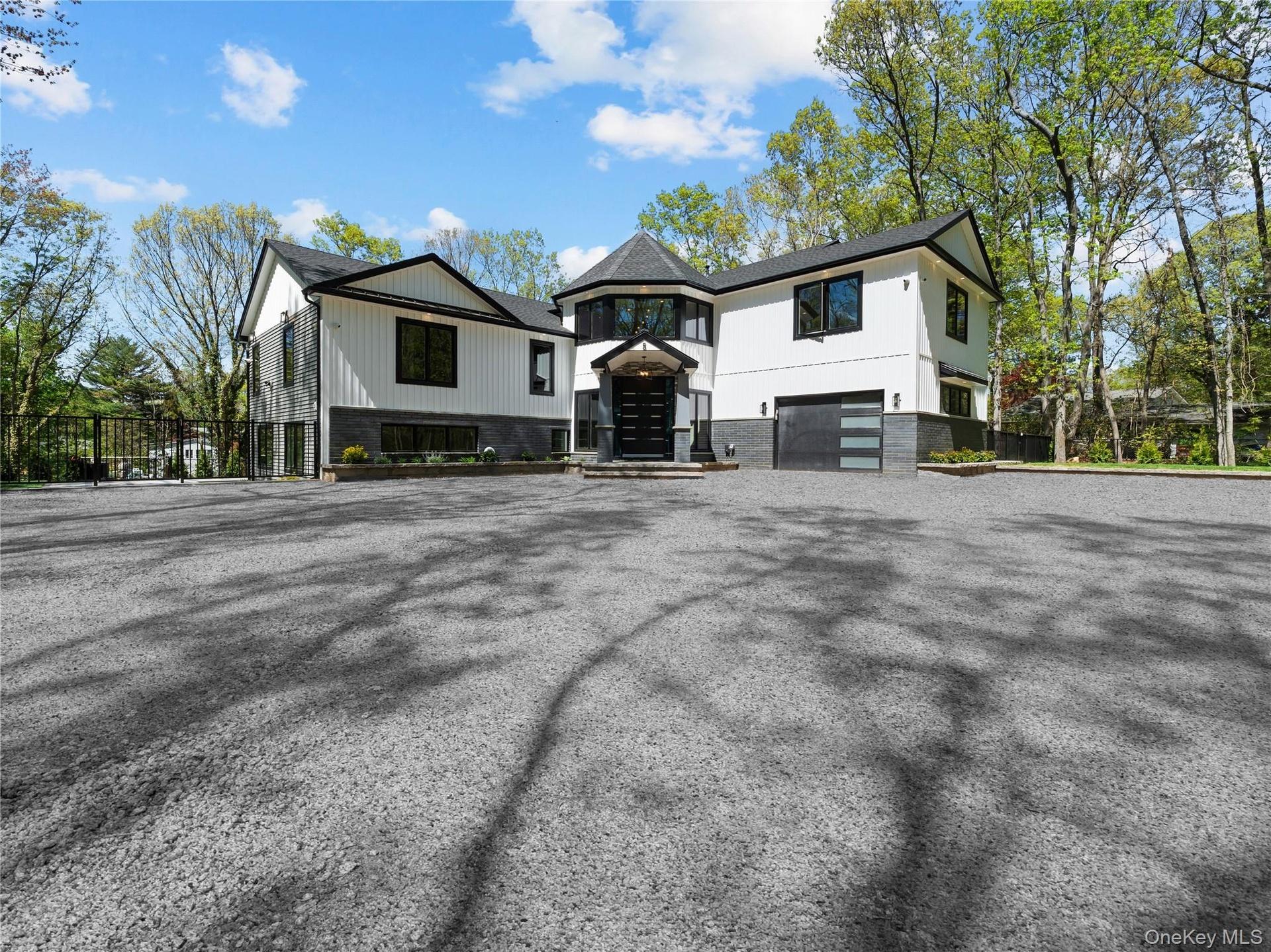 View of front of house featuring a garage and driveway