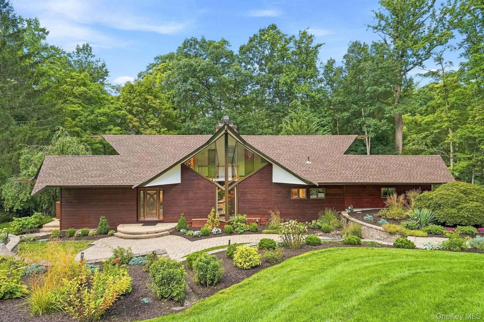 Designed by Westchester architect Roy Sigvard Johnson, this distinctive 1969 Mid-Century Modern residence showcases sculptural rooflines, dramatic ang