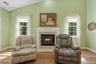 Vaulted ceiling, fireplace with mantel, dual paned windows, wood-finish flooring
