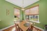 Wood-finish flooring with white trim and baseboards