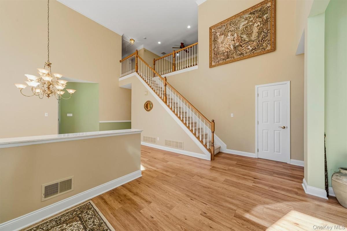 Open area living room with access to stairs