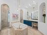 Primary Bath with Marble Floors, Walls and Marble Slab Vanity Tops and Walk Around Shower