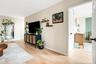 Living area with light wood finished floors and baseboards