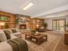Walkout Family room with woodburning fireplace / Virtually Staged