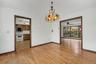 Dining room with hard wood floors leading to kitchen and living room