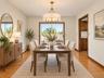 Dining room featuring sliders to deck and hard wood floors / Virtually Staged