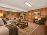 Walkout Family room with woodburning fireplace / Virtually Staged