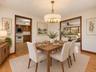 Dining room featuring sliders to deck and hard wood floors / Virtually Staged