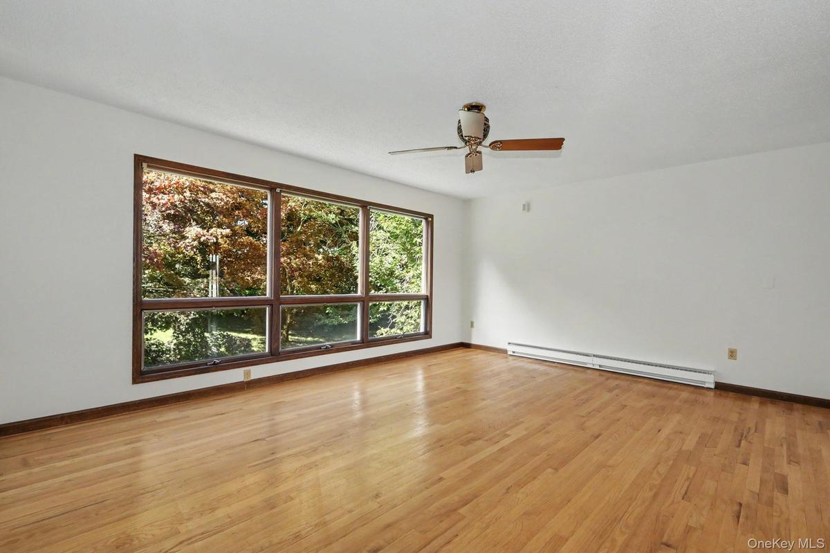 Living room with large windows and hardwood floors