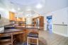 Kitchen features a tiled backsplash, custom lighting, and abundant counter space, including this perfect work area.