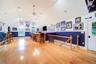 This spectacular Bonus Room is currently an enviable sports room. Radiant heated floors, high ceilings and a custom wood carved bar make this the perf