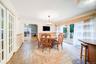 Patterned tile flooring, french doors to dining room, glass patio doors, wood-finish flooring, and a decorative chandelier make this a perfect area fo