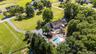 Beautiful corner lot with private inground swimming pool surrounding patio, gazebo, expansive green space, and mature trees