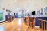 Bonus room has recessed lighting, hardwood floors, multiple windows, a door to the side yard and a full bath in the space