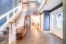 Two-story foyer featuring tile flooring and a grand staircase with wood-finish handrails and custom molding