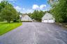 Expansive paved driveway with a separate detached two-car garage. Room for everyone!