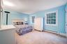 Bedroom #5 Is carpeted and features multiple windows and a large closet.