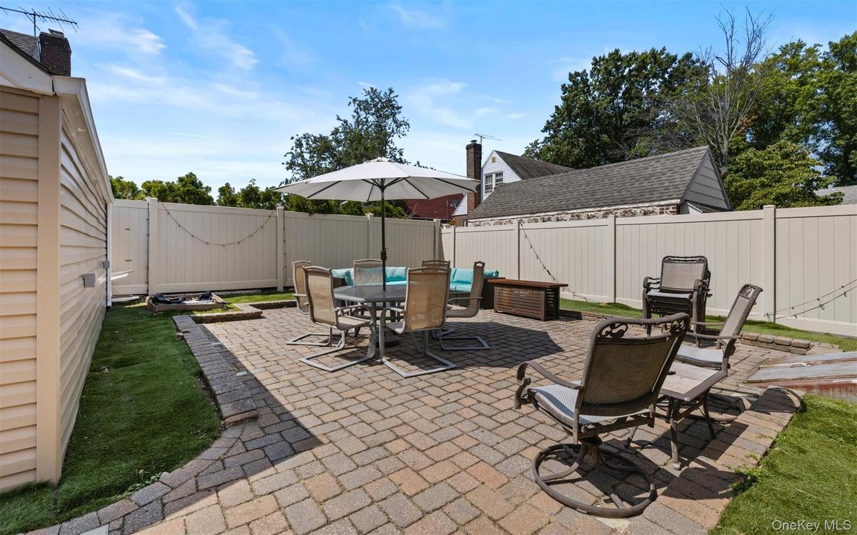 Fenced backyard featuring a patio area and outdoor dining space