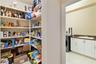 This walk-in pantry and laundry room are accessible through the arch in the previous picture of the kitchen.