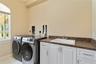The Landry room offers storage shelving on the wall not shown in this picture.  Notice the two outlets and dryer vents. This laundry room was designed