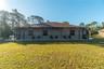 This is the lanai in the guest house mentioned earlier. The lanai overlooks the pond, fire pit and part of the yard. The three windows belong to suite