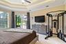Primary bedroom. Notice the natural light and the slider leading to the pool. Also, notice the tray ceiling.