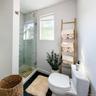 Virtually staged. Bathroom with glass walk-in shower and natural light from the window.