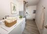 Virtually staged. Laundry area with side-by-side washer and dryer and hallway access.