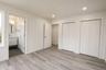 Primary bedroom with two closets and direct access to the bathroom.