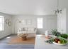 Virtually staged. Living area off the kitchen with windows and wood-look plank flooring.