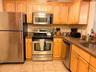 Wood cabinets, stainless steel appliances.