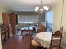 Spacious open layout living room/dining room with view of the courtyard and heated swimming pool