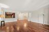 Hardwood flooring, crown molding, pass-through kitchen opening, built-in cabinetry, recessed lighting