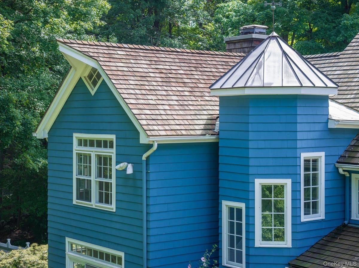 Cedar shingle multidimensional roof line & copper roof turret
