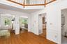 Shows living room, dining room, guest closet, door to kitchen, half bathroom and partial view of balcony